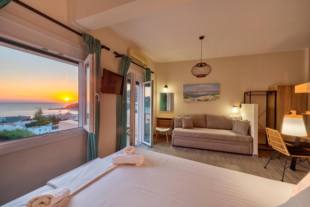 a bedroom with a bed and a view of the ocean at Guesthouse ERI in Kini
