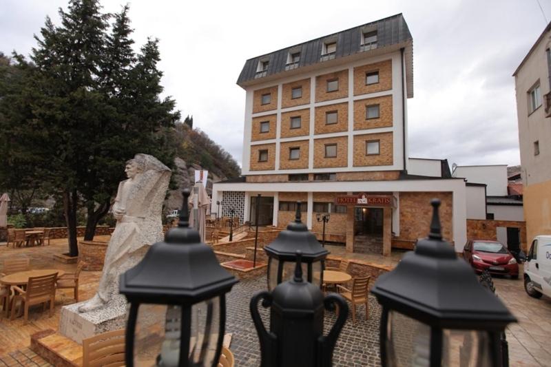 a statue of a woman standing in front of a building at Hotel Kratis in Kratovo