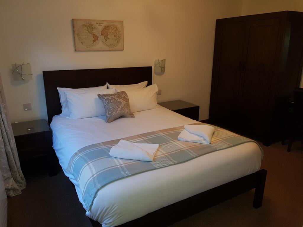 a bed with two pillows on it in a bedroom at Bay Lodge in Birchington