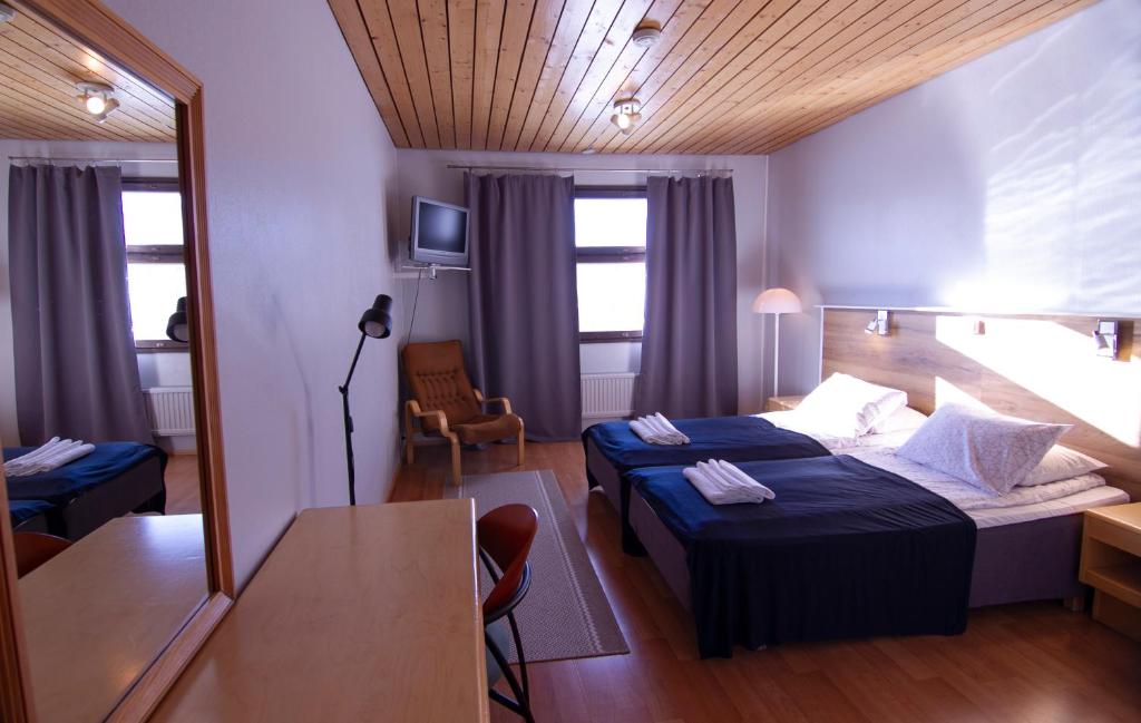 Postel nebo postele na pokoji v ubytování Hotelli Peltohovi