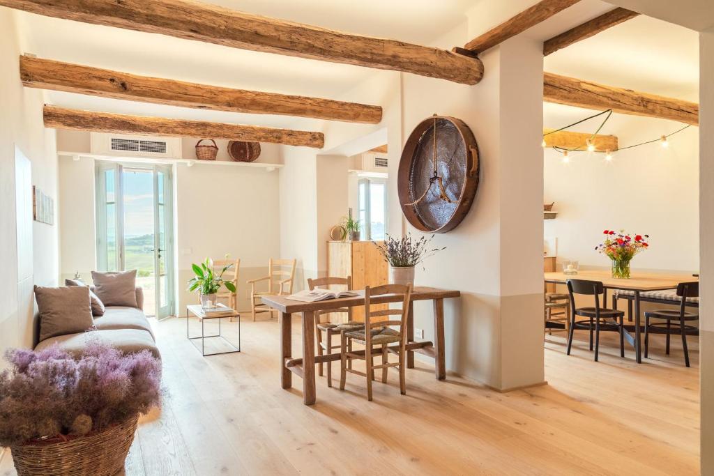 uma sala de estar com uma mesa e cadeiras e um sofá em CUGUSI BnB em Montepulciano