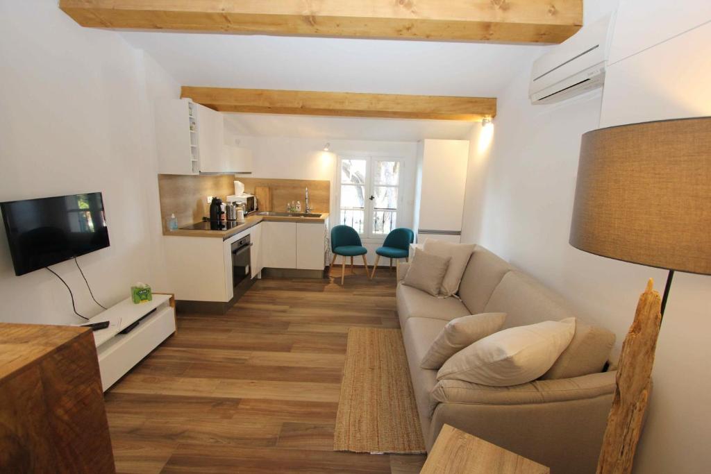 a living room with a couch and a kitchen at Domaine Chateau Martin in Saint-Tropez