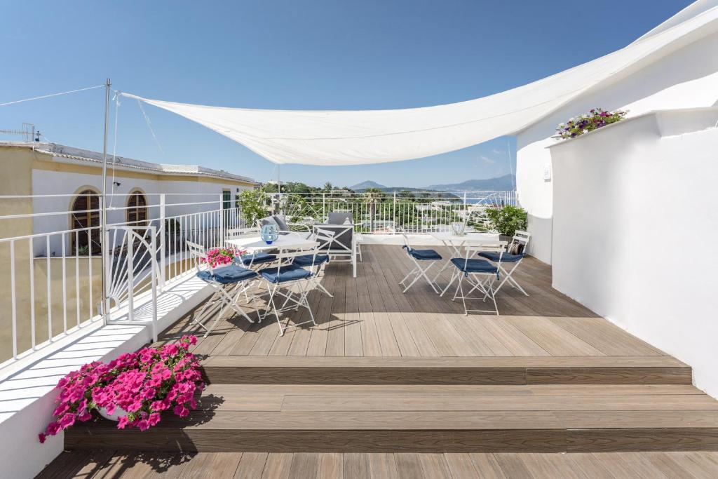 a balcony with a table and chairs on a building at Le Volte Procida Home in Procida