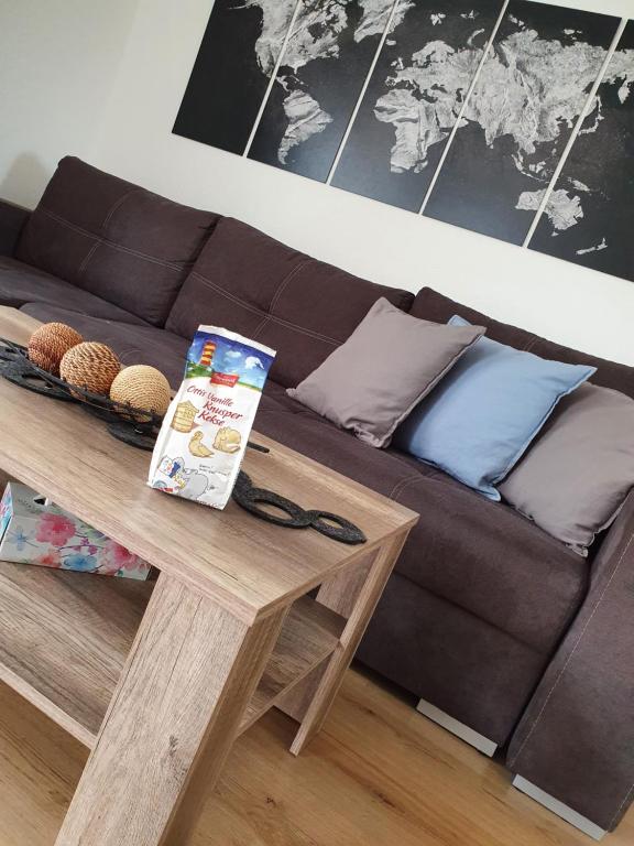 a living room with a brown couch and a table at Wohnung Westerholt in Westerholt