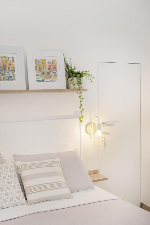 a white bedroom with a bed with a white headboard at Le Volte Procida Home in Procida