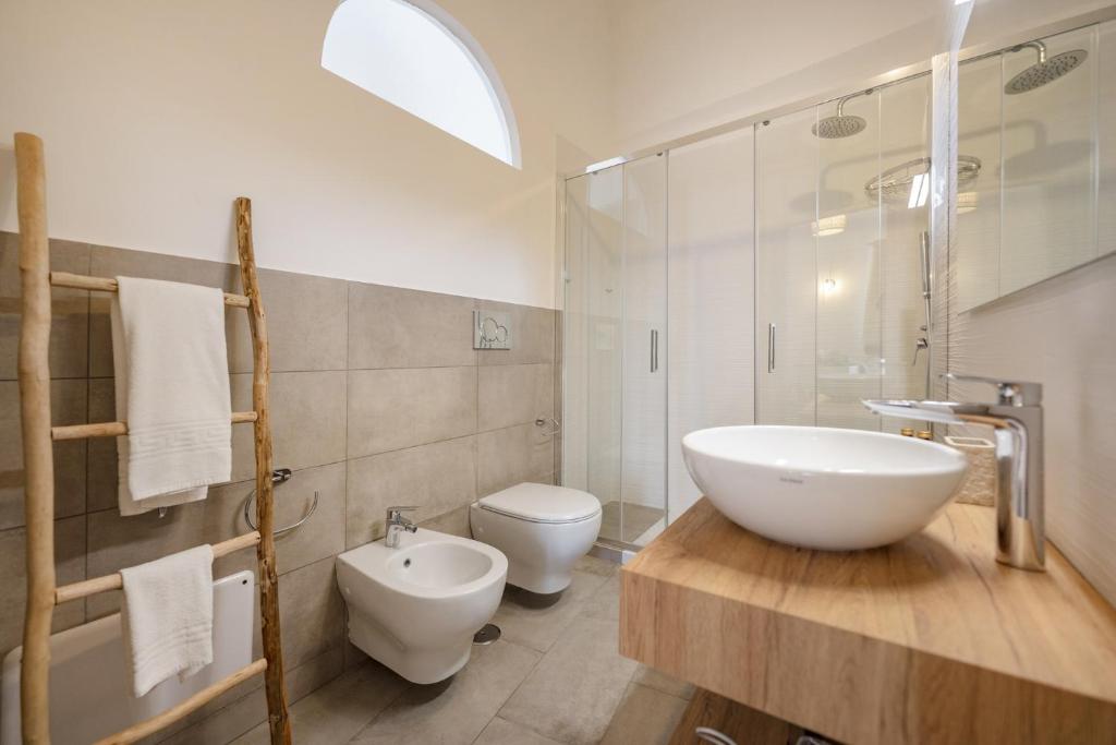 a white bathroom with a sink and a toilet at Le Volte Procida Home in Procida