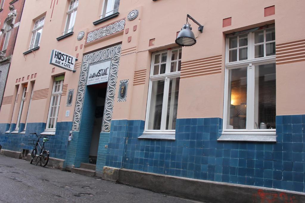 a pink and blue building with a bike parked outside at schickSAAL* in Lübeck