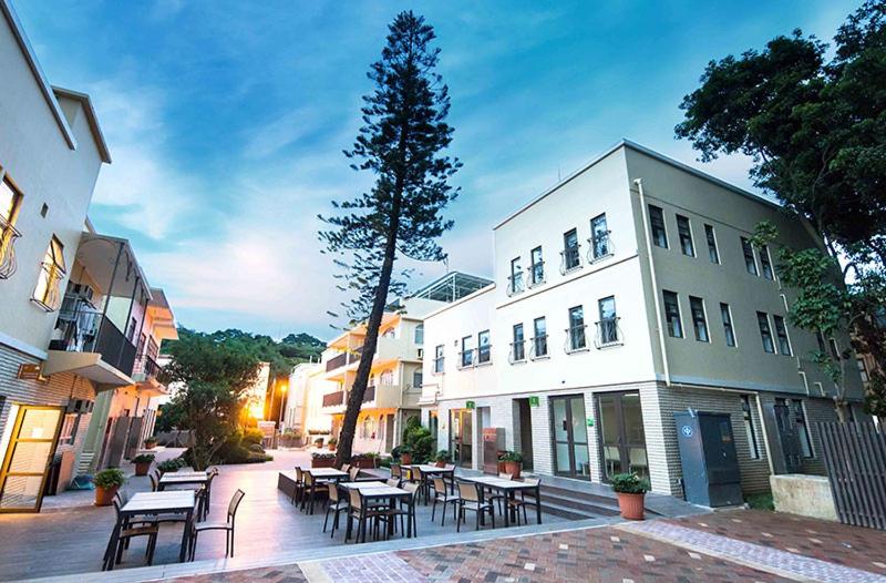 a building with tables and chairs in a courtyard at Solar Villas in Hong Kong