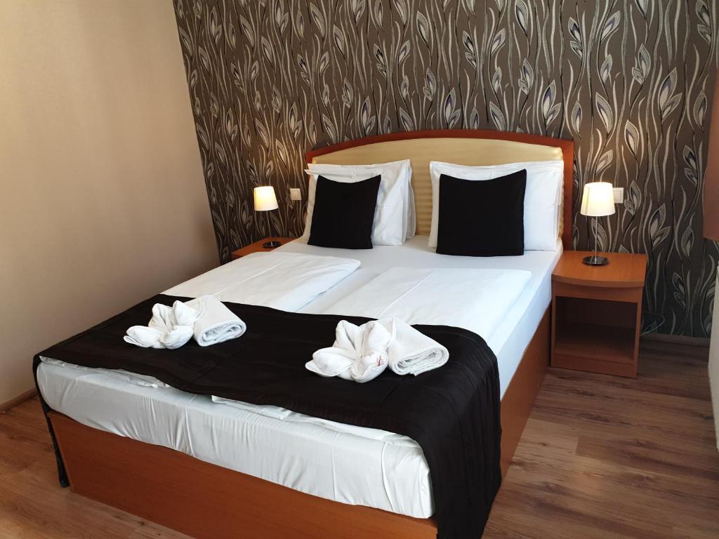 A bed or beds in a room at Six Inn Hotel Budapest