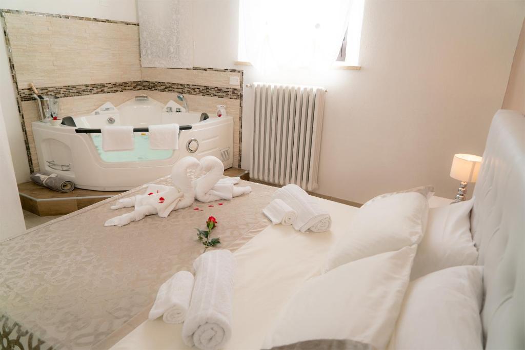 a bedroom with a bed with towels on it at Barbarossa in Siena