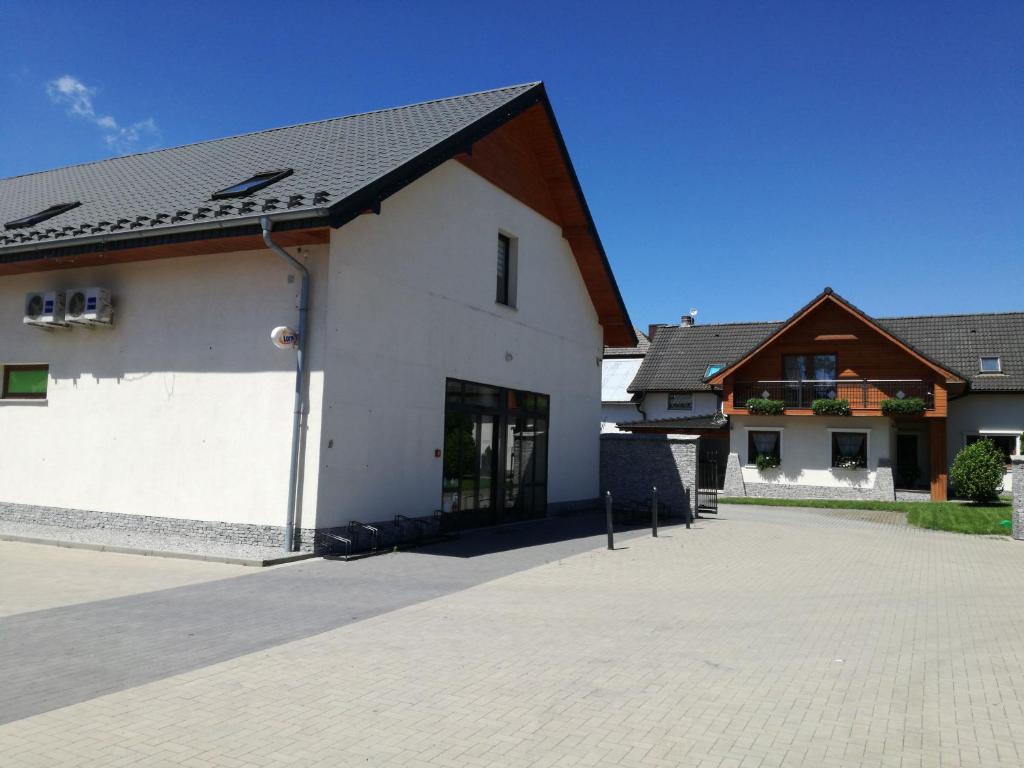 a white building with a black roof at U Justyny in Chróścice