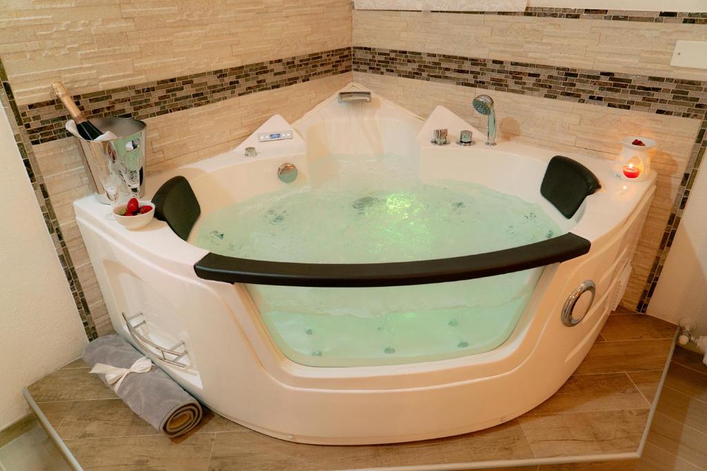 a bath tub in the middle of a bathroom at Barbarossa in Siena