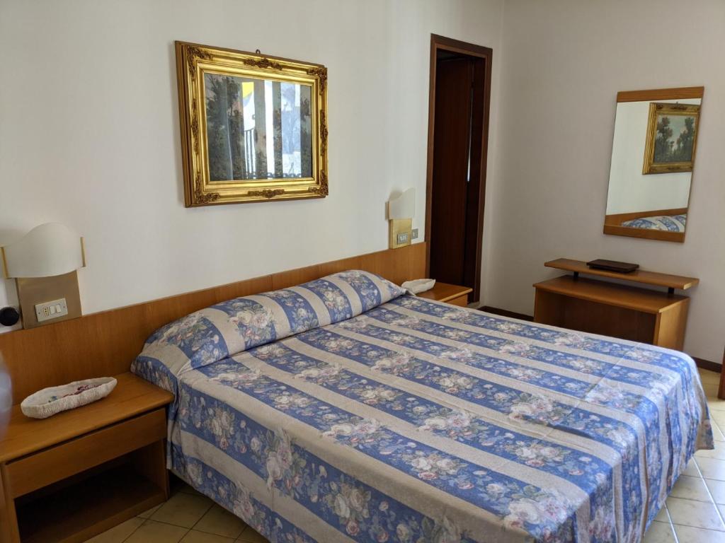 Postel nebo postele na pokoji v ubytování Hotel Corallo