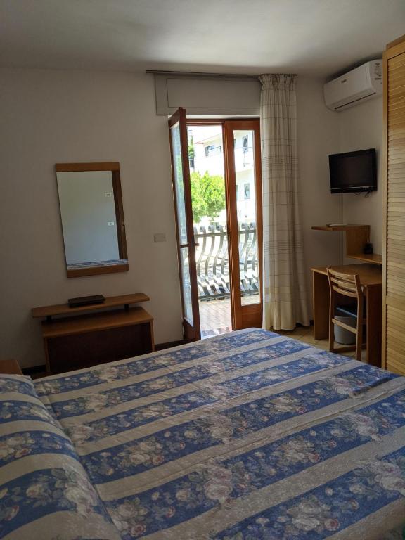 Postel nebo postele na pokoji v ubytování Hotel Corallo