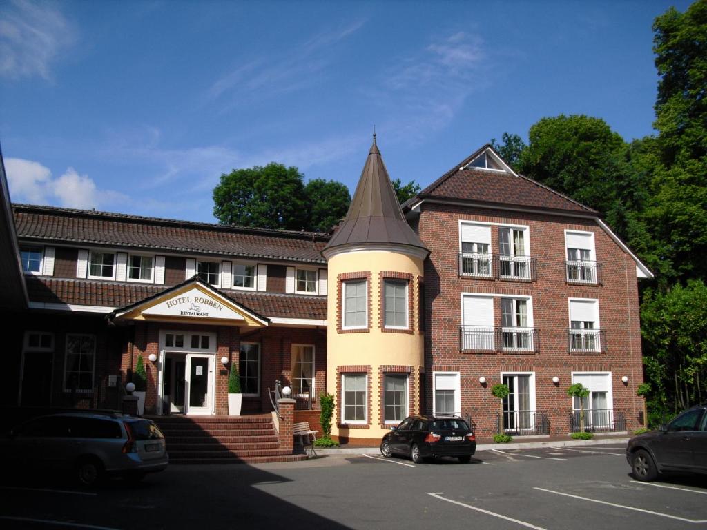 a building with a pointed turret on a street at Hotel Robben in Bremen