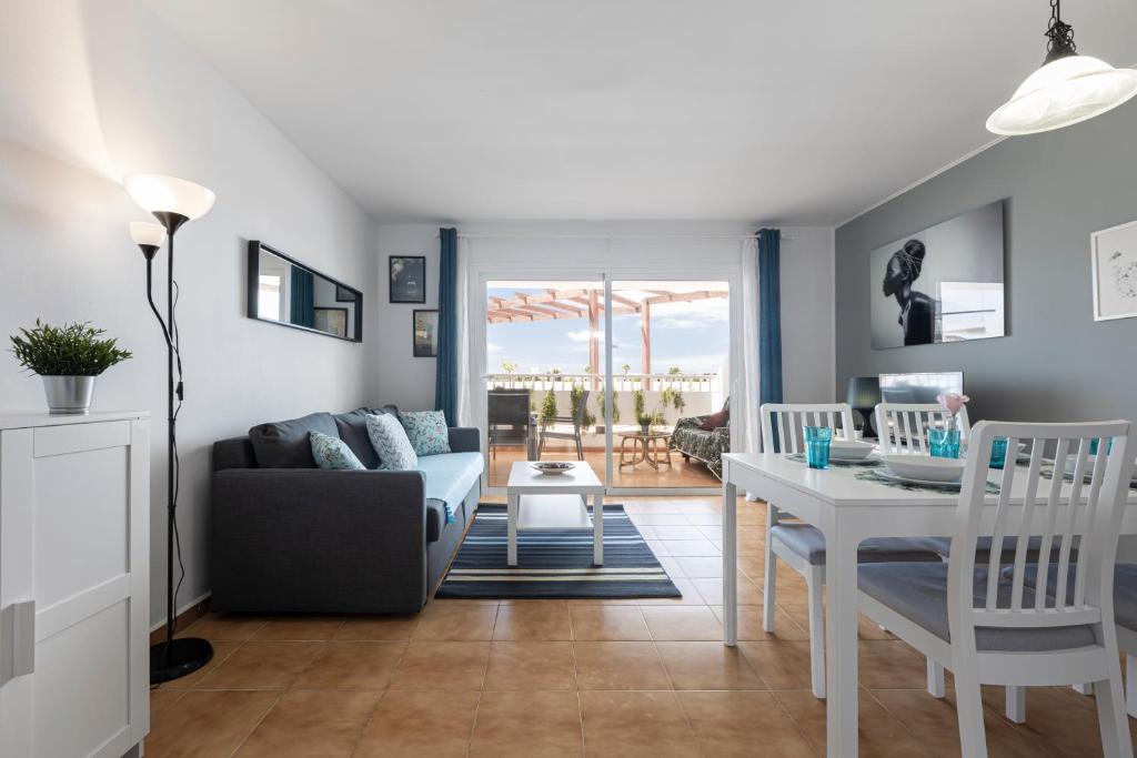a living room with a couch and a table at The Colors House, 646 y 524 - Private Apartments in Costa Teguise