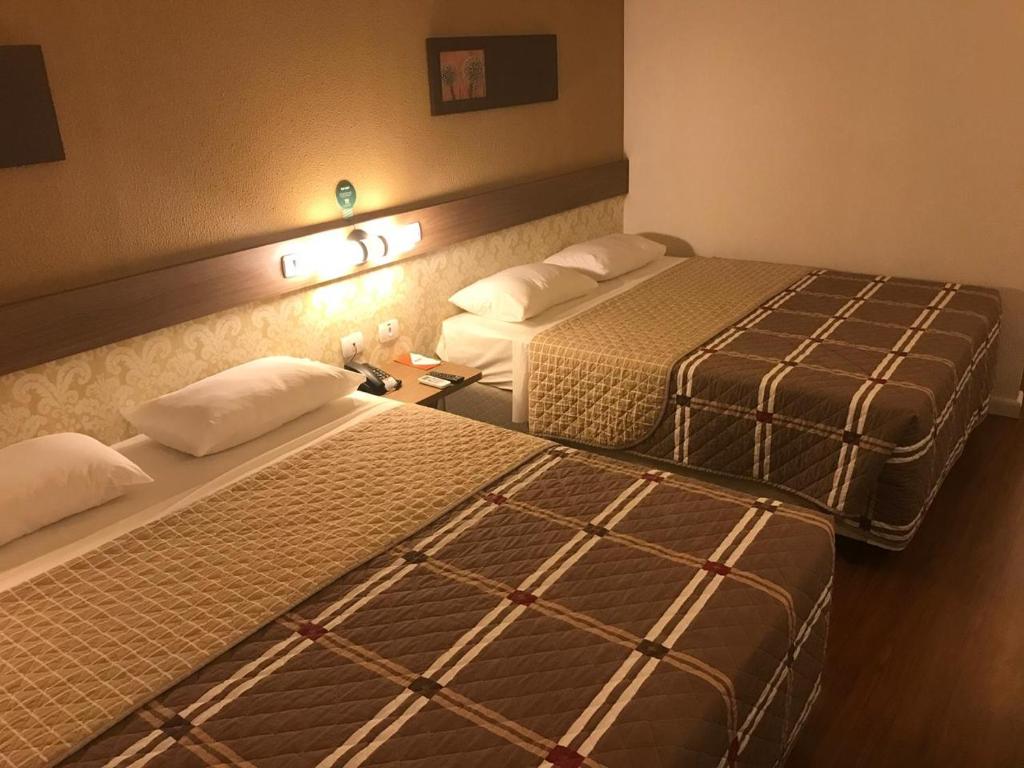 Ένα ή περισσότερα κρεβάτια σε δωμάτιο στο Hotel 10 Palmas
