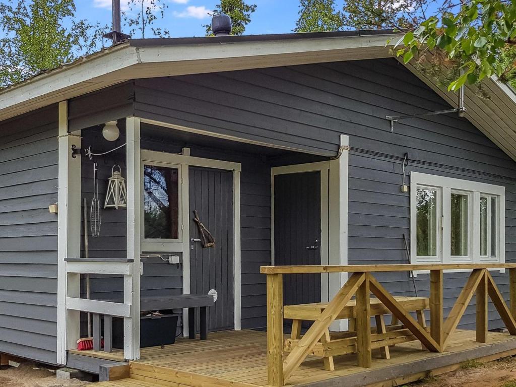 a small house with a porch and a deck at Holiday Home Mukan maja by Interhome in Köngäs