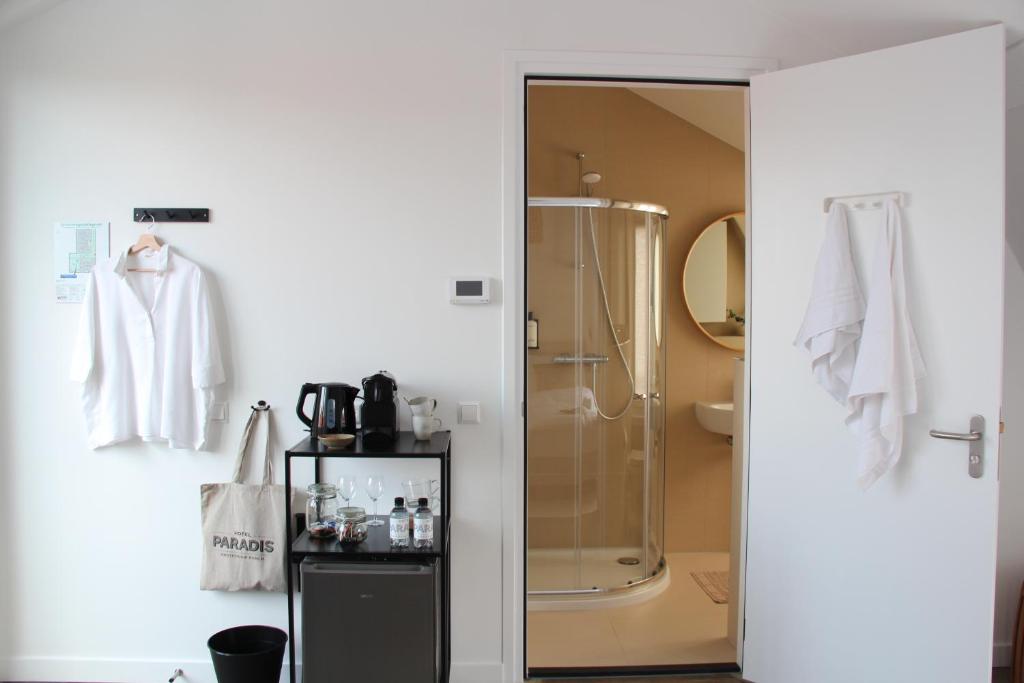 
a bathroom with a shower and a sink at Hotel Paradis in Zandvoort
