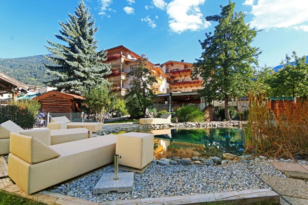 a living room with a couch and a pond at Hotel Enzian in Landeck