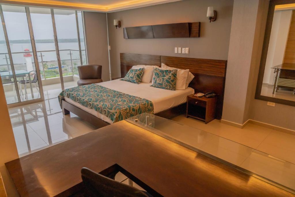 a hotel room with a bed and a balcony at Torre Mar in Buenaventura