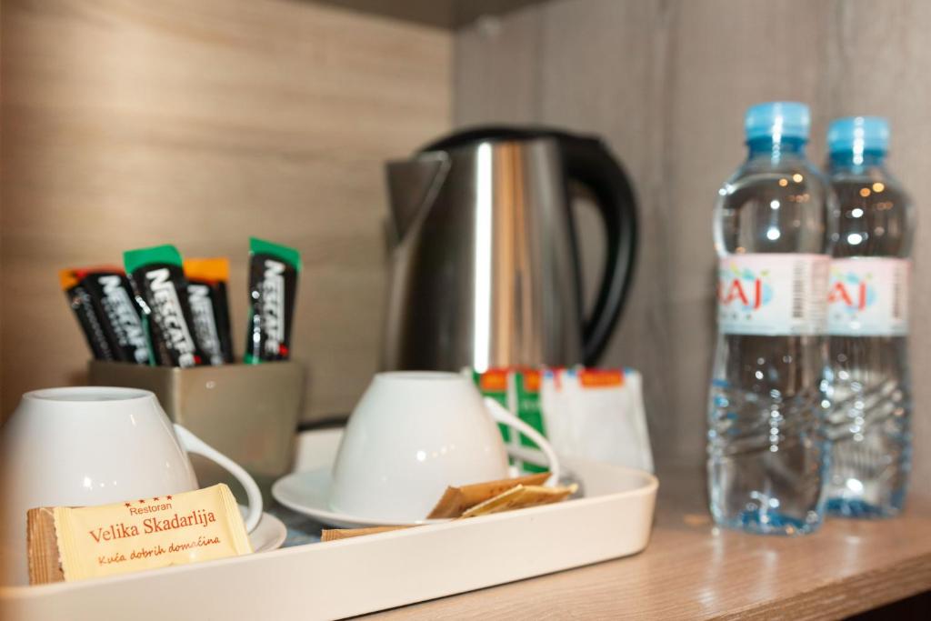 a table with a tray with a bottle of water at Skadarlija Suites in Belgrade