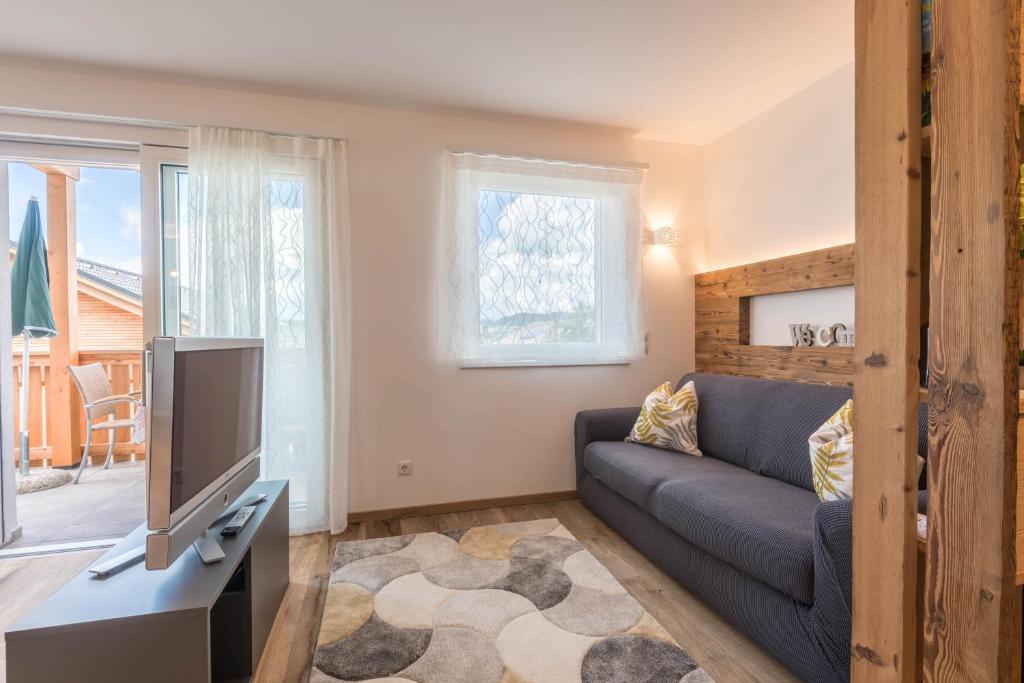 a living room with a couch and a tv at Apartment Roderer in Völs am Schlern