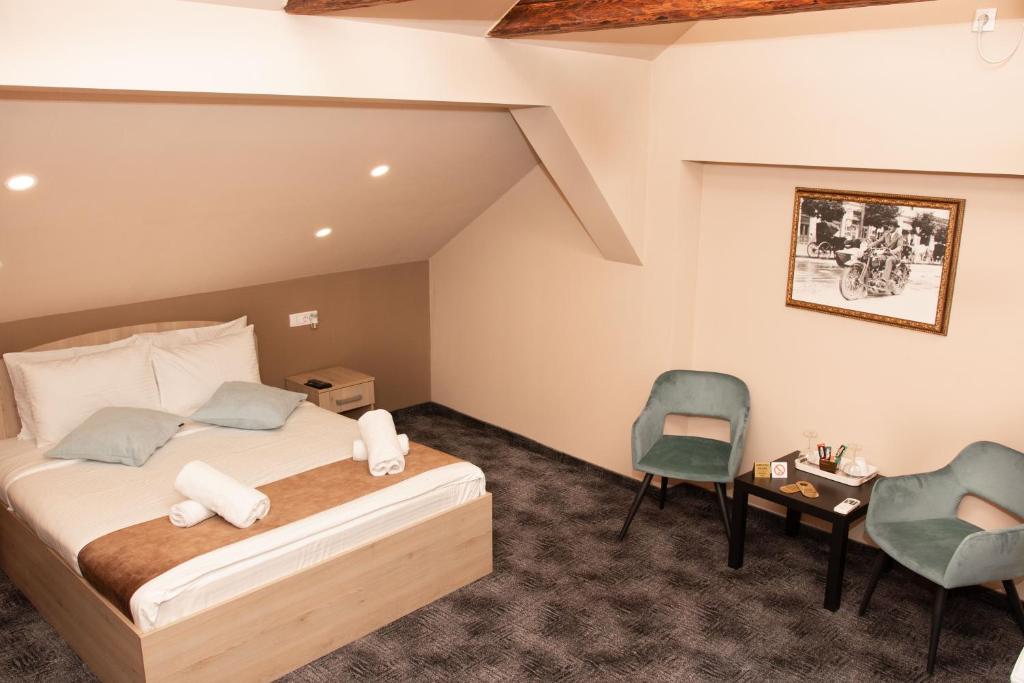 a bedroom with a bed and a desk and a chair at Skadarlija Suites in Belgrade