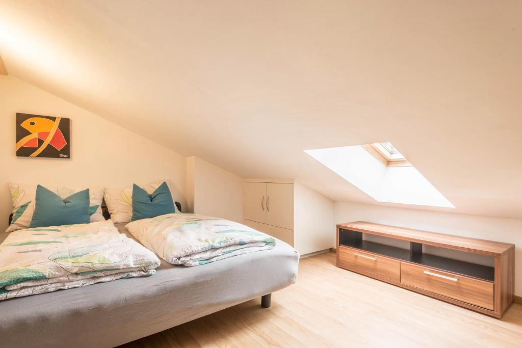 a attic bedroom with a bed and a skylight at Apt Hetti - Haus Kostner in Santa Cristina Gherdëina