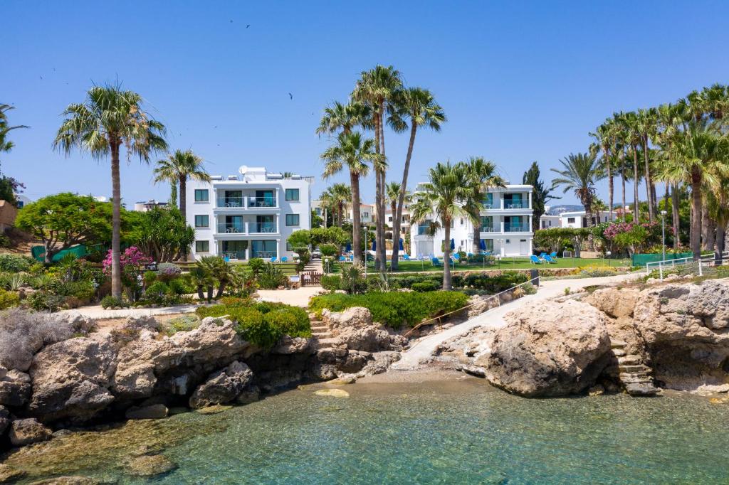 a view of a resort from the water at Rododafni Beach Apartments in Paphos