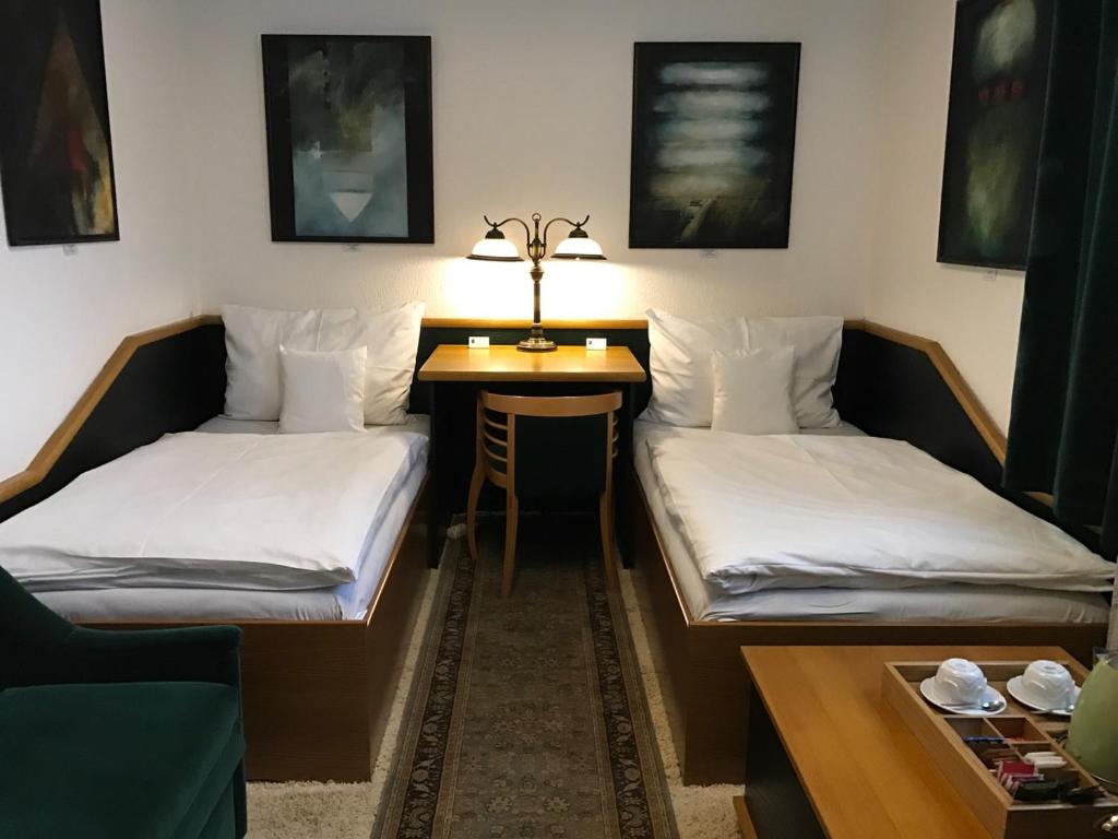 a living room with two beds and a table at Antik Hotel Sofia in Litomyšl
