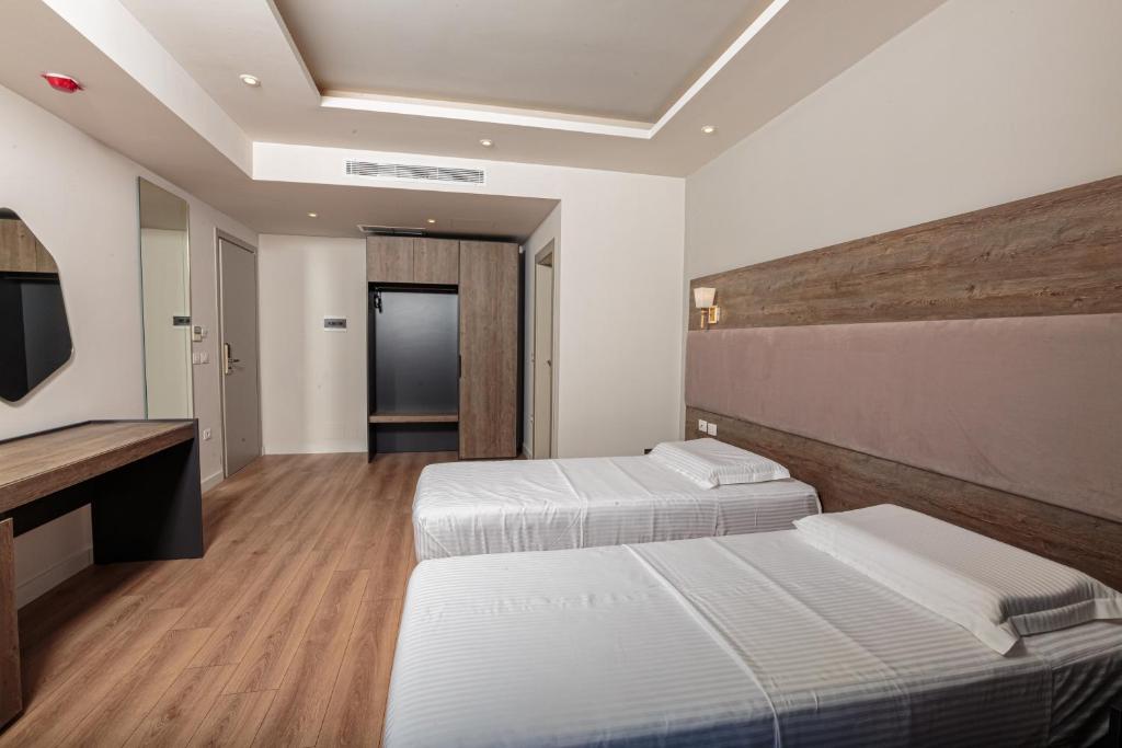 Postel nebo postele na pokoji v ubytování Real Hotel