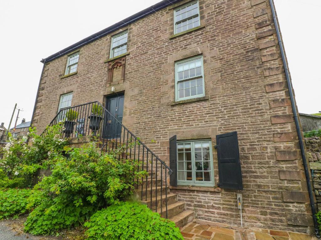 a brick building with stairs and windows at Old Methodist Chapel in Buxton