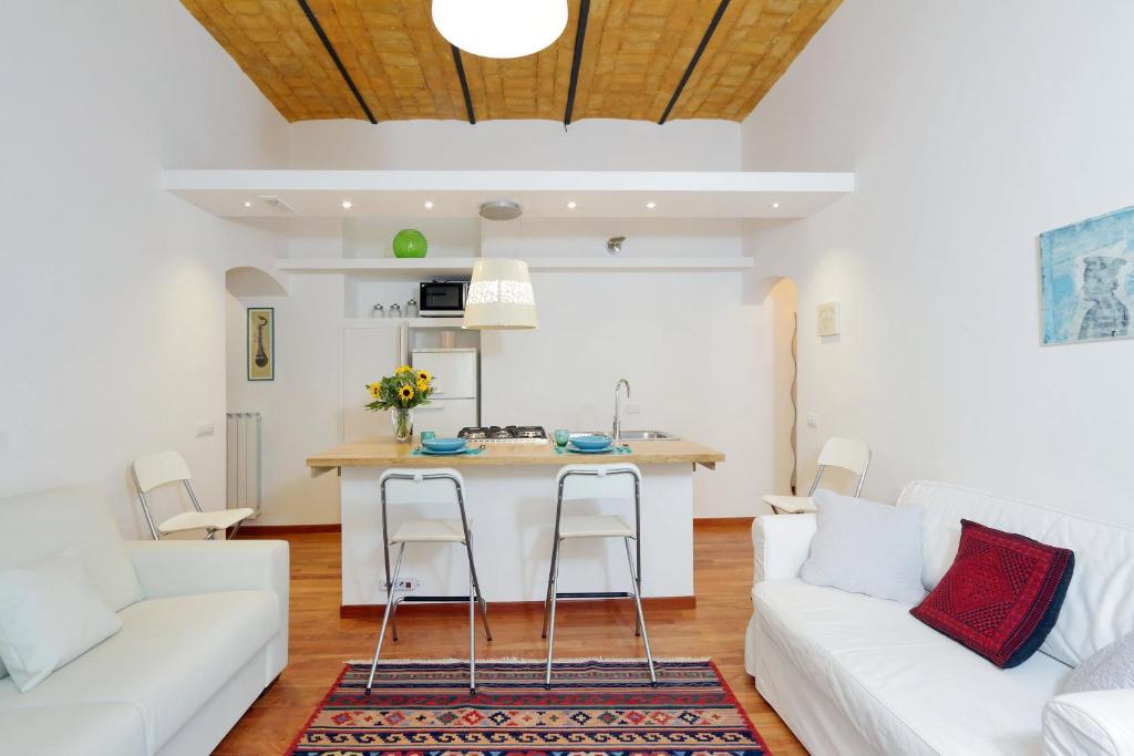 a living room with a white couch and a table at RomeAsYouLike - Colosseo Experience 23 in Rome