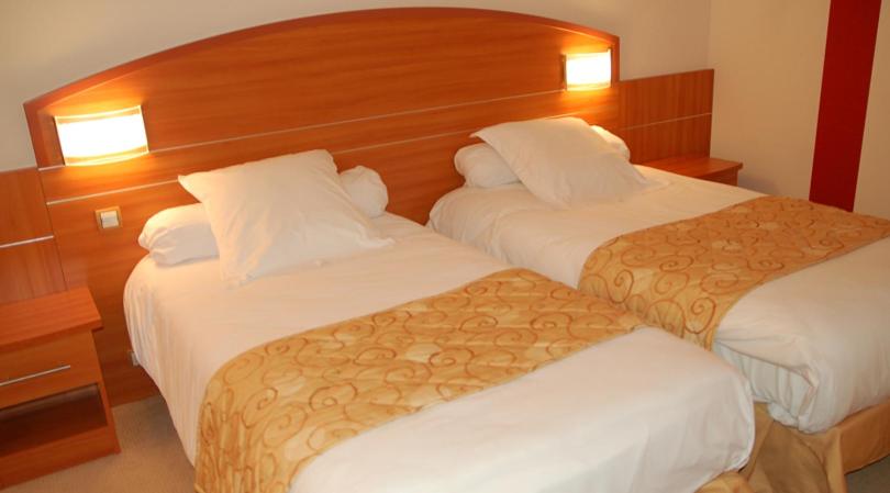 Postel nebo postele na pokoji v ubytování Hotel Cigoland