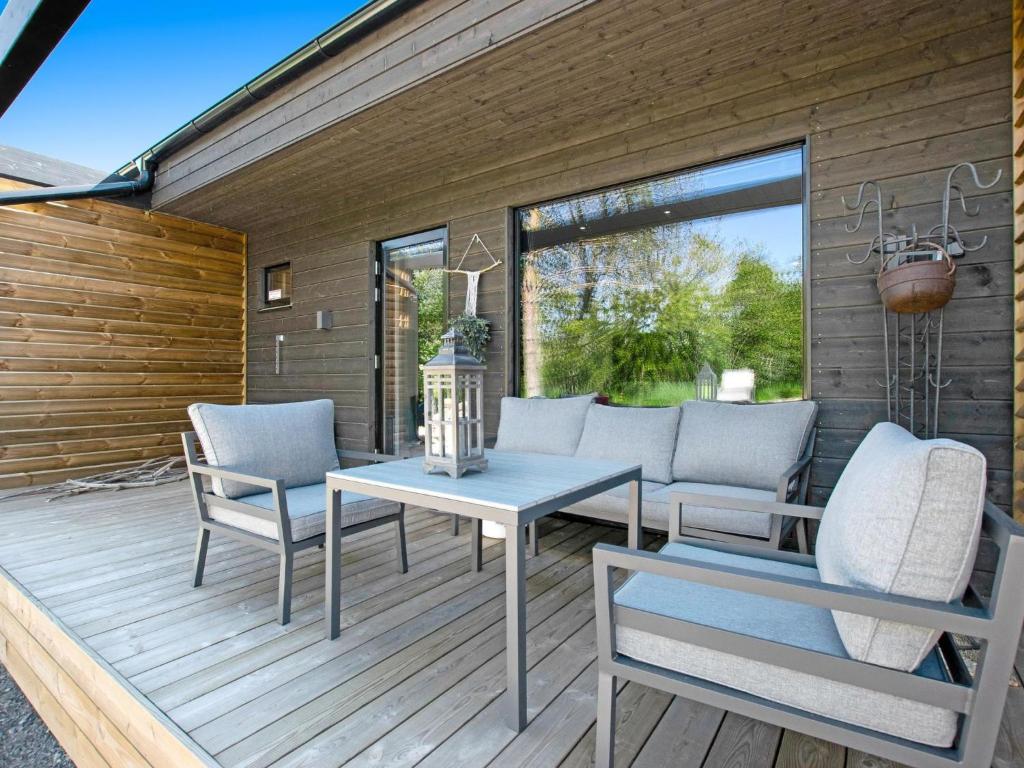 a patio with a table and chairs on a wooden deck at Holiday Home Kasnäs marina b12 by Interhome in Kasnäs