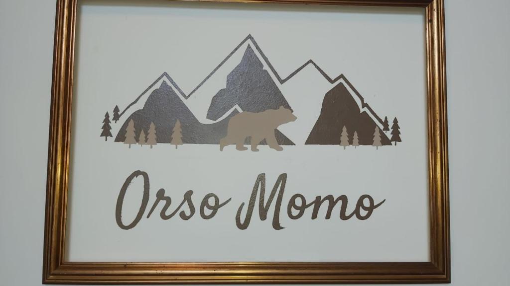 a framed picture of a wolf in the mountains at Orso Momo in Calizzano