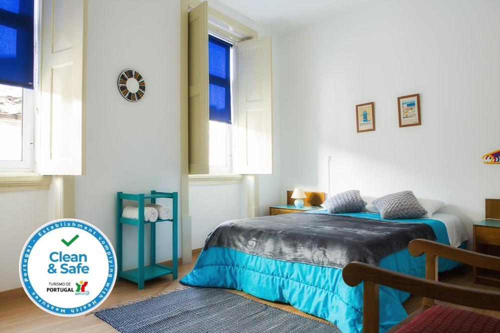 een slaapkamer met een bed en een raam bij Olive Street House in Coimbra