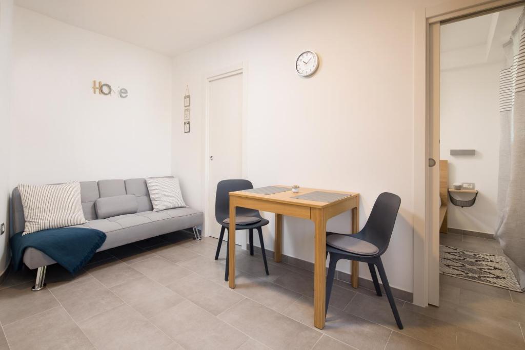 a room with a table and chairs and a couch at Apartments Beni in Matulji