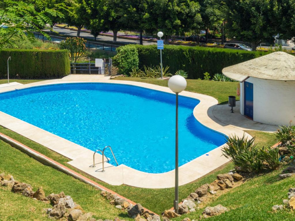 a swimming pool in a yard next to a house at Holiday Home Sol de Estepona by Interhome in Estepona
