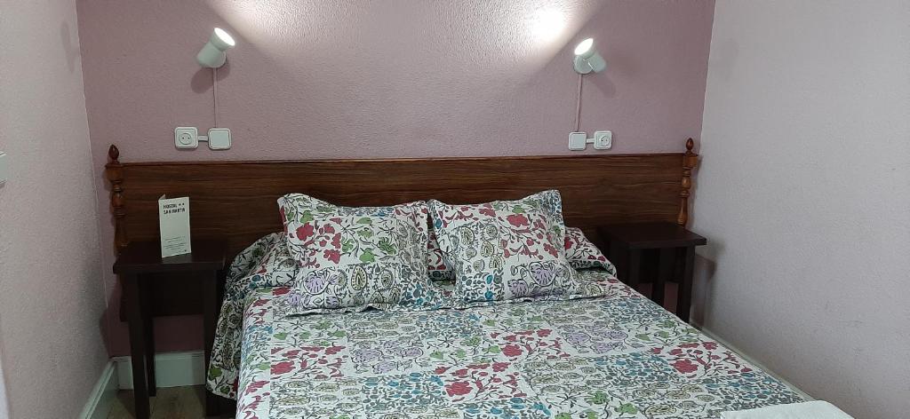 A bed or beds in a room at Hostal San Martin