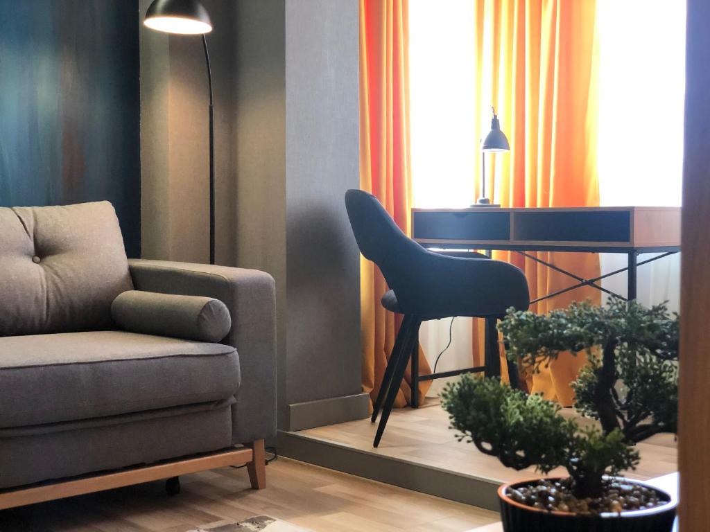 een woonkamer met een stoel en een bank bij GoConcept Studio in Iaşi