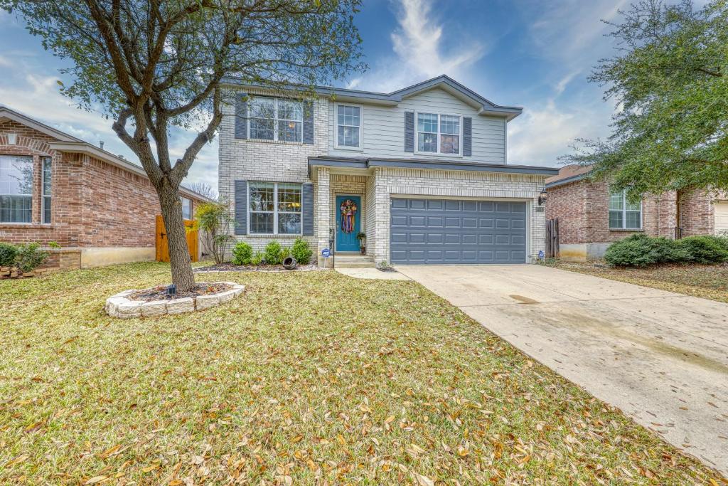 a house with a tree and a garage at Living the Dream in San Antonio