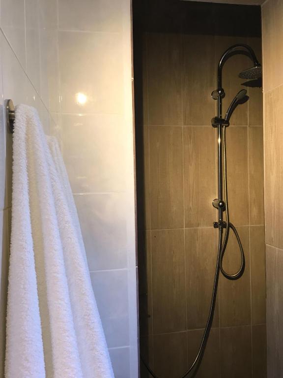 a bathroom with a shower with a white towel at Carrapateira Lodge in Carrapateira