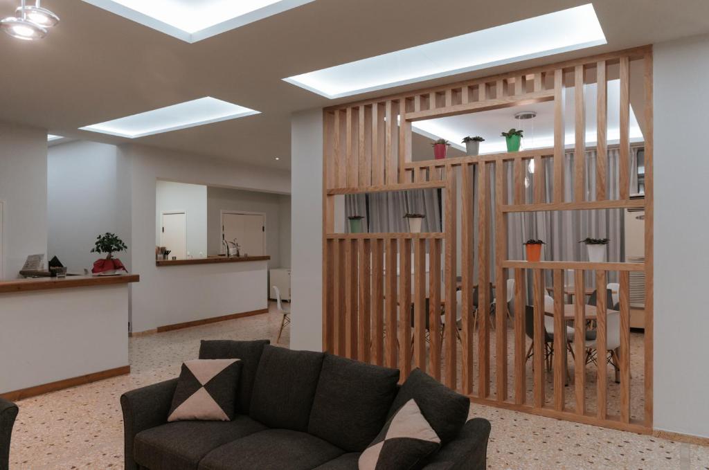 a living room with a couch and a staircase at Vivari Acta in Vivari