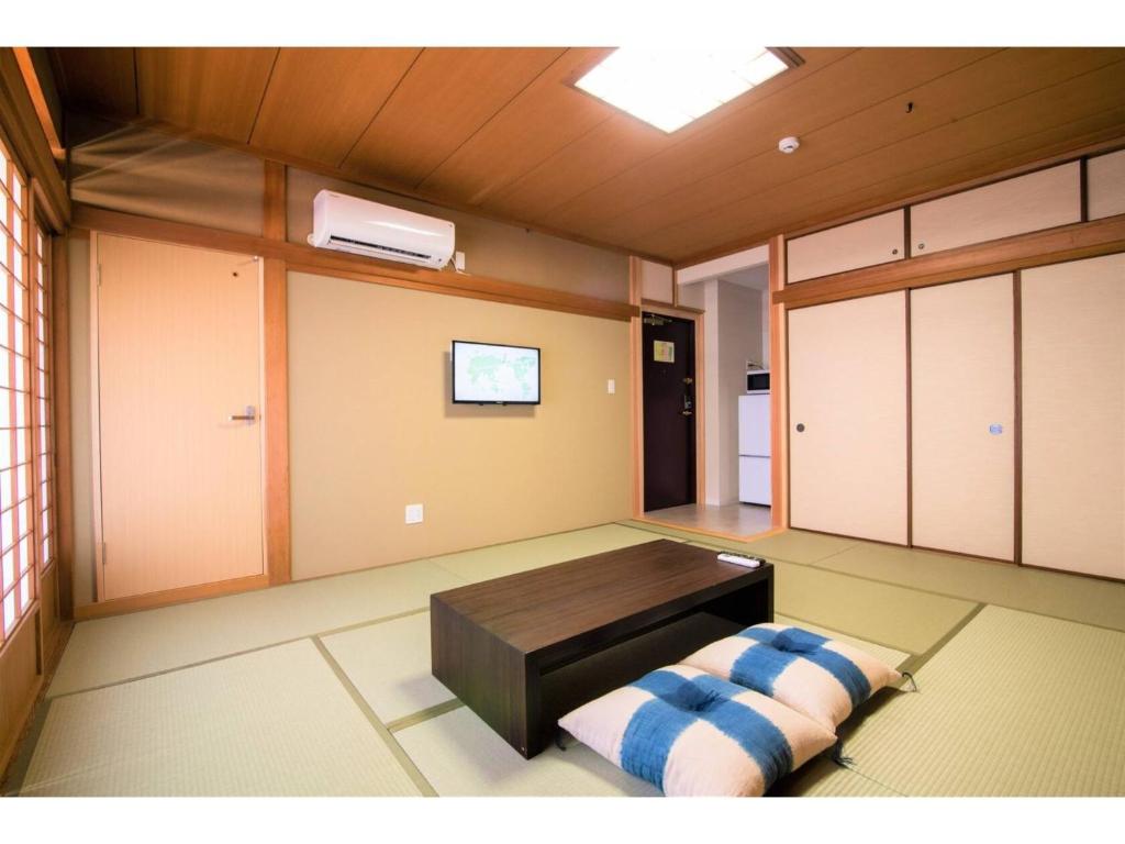 a room with a table and a bench in it at Arbor house - Vacation STAY 86735 in Kagoshima