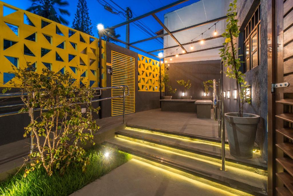 a set of stairs leading to a patio with plants at Liiv Cobogó - Natal Ponta Negra in Natal