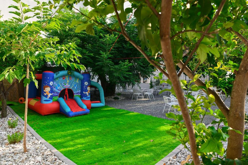 a playground in a garden with green grass at Vivari Acta in Vivari