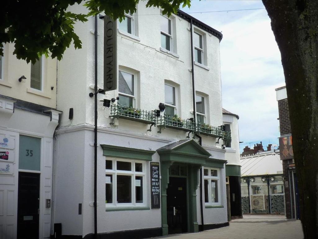 a white building with a balcony on a street at City Space in Doncaster