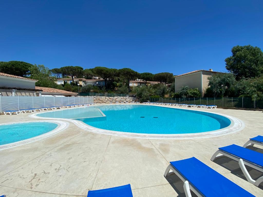 a large swimming pool with blue lounge chairs at Appartements MISTRETTA 33 Bouddha Zen 34 Arts Appart 44 NY City in Sainte-Maxime